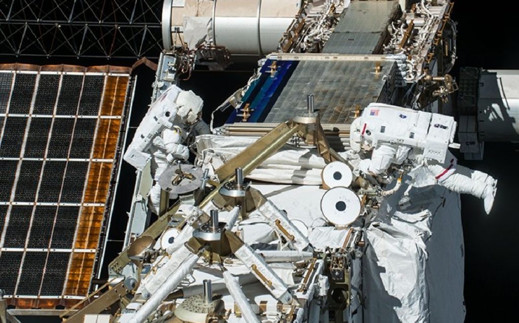 Container.  Astronauts prepare the International Space Station to install new solar panels