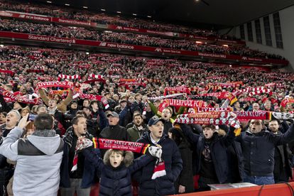 Liverpool fans cheer for their team at Anfield in a match against Everton in December 2019.