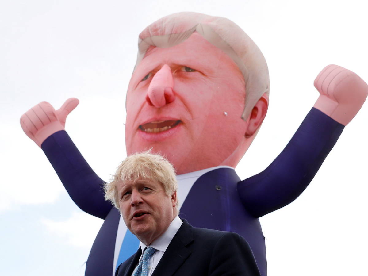 Photo: Boris Johnson, British Prime Minister, poses in front of a giant inflatable doll posing as him.  (Reuters)