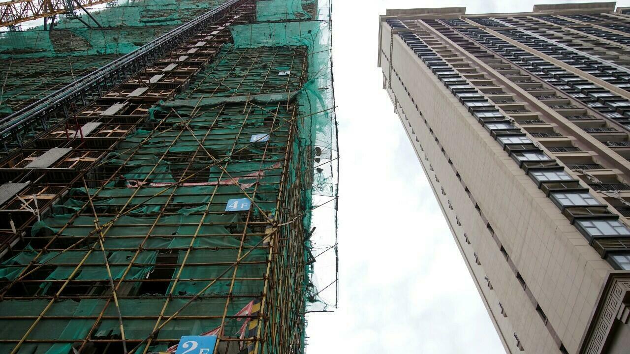 Scaffolding surrounds an unfinished apartment building in the city of Evergrande for Cultural Tourism, one of the projects of the Chinese Evergrande Group that has been discontinued, in Suzhou Taikang, Jiangsu Province, China on October 22, 2021.