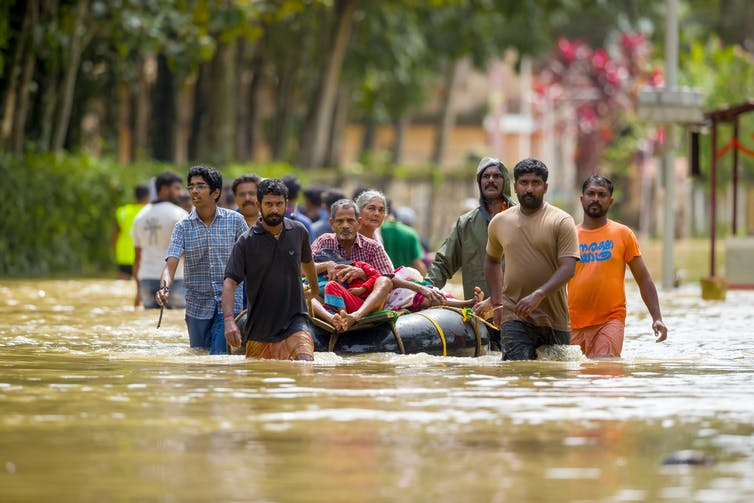 People walking on a flooded street